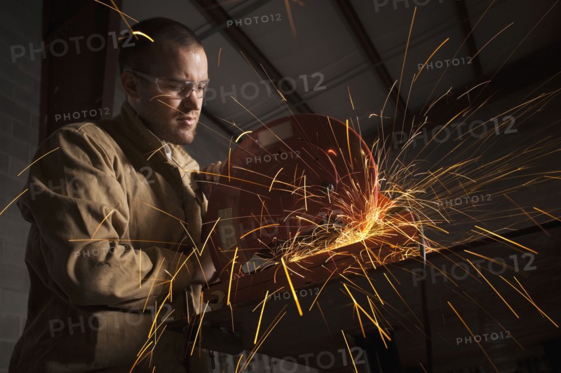Steel grinder working in metal shop
