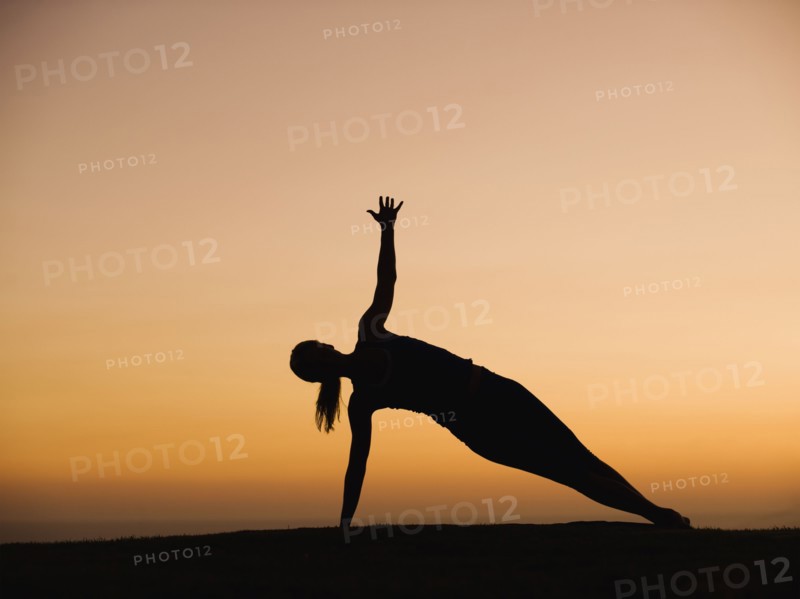 Silhouette of woman doing yoga
