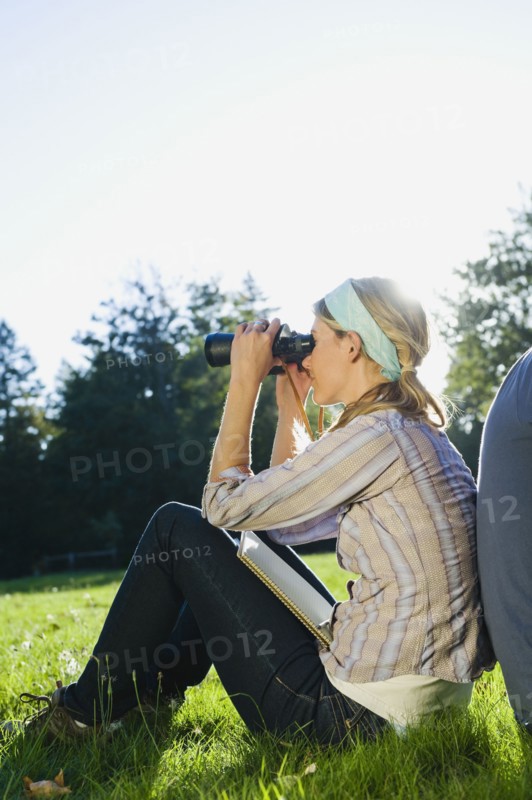Woman looking through binoculars