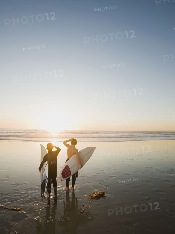 Kids on beach with surfboards