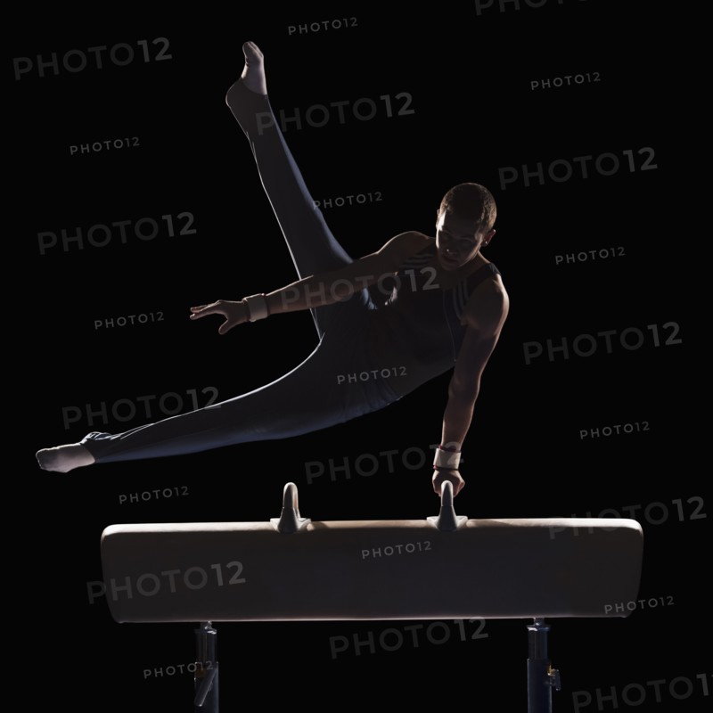 Male gymnast on pommel horse