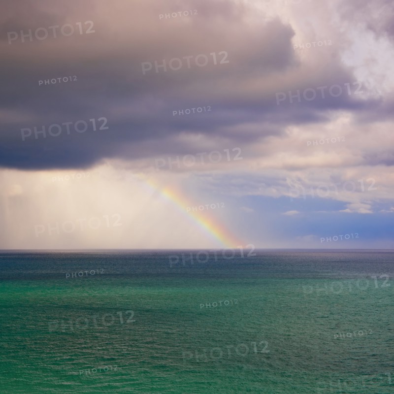 Rainbow over ocean.