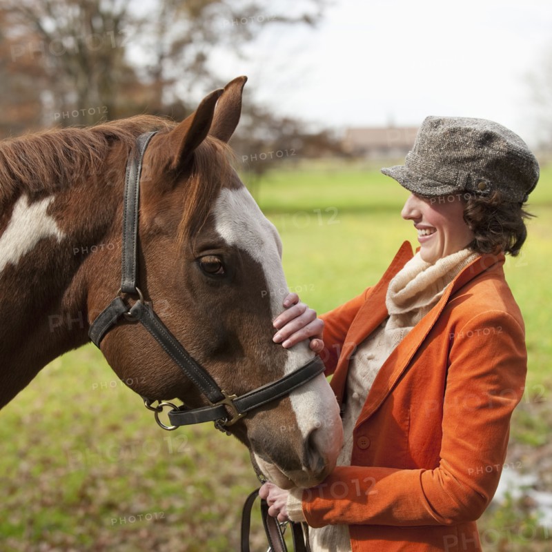 Woman petting horse.