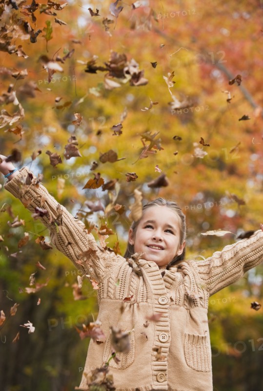 Girl throwing leaves.