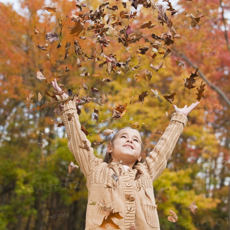 Girl throwing leaves.