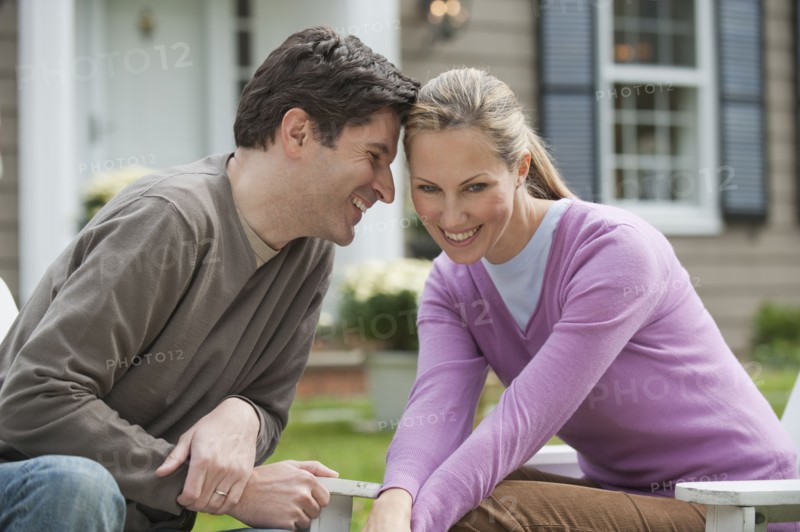 Couple in front of house.