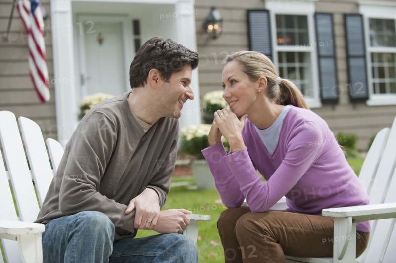 Couple in front of house.