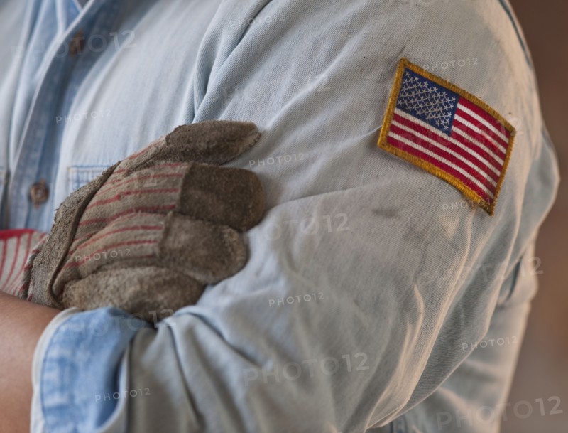 Blue collar working wearing American flag patch.