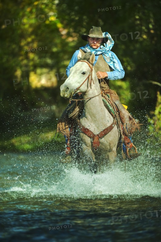 Riding horse through water.