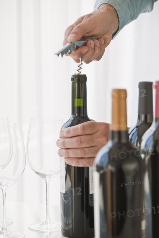 Uncorking wine.