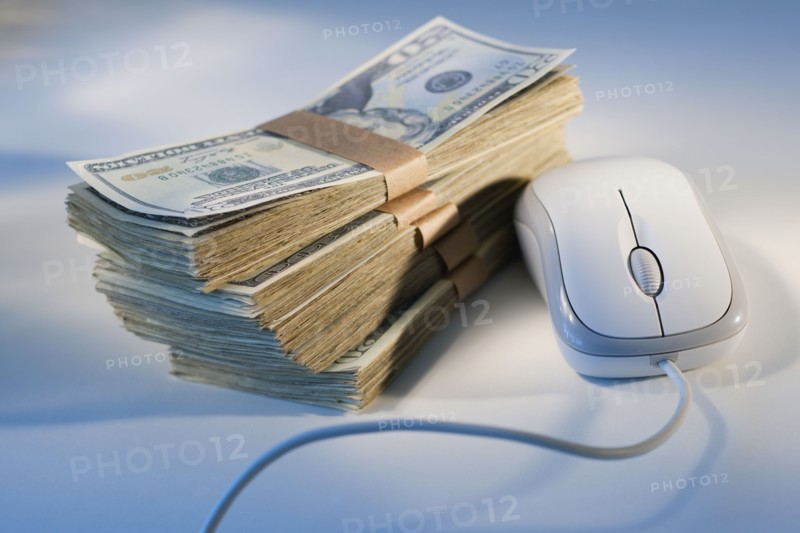 Computer mouse beside money.