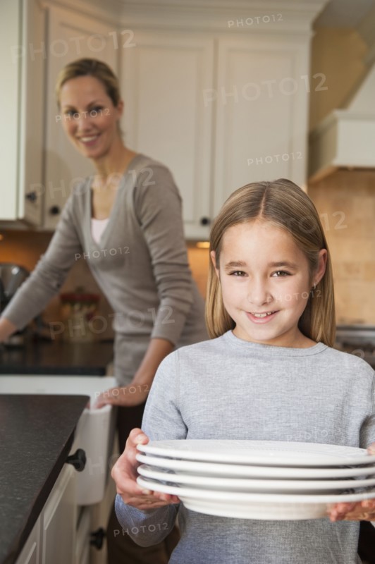 Girl holding plates.