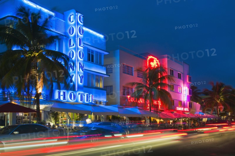 Illuminated buildings and car lights at night.