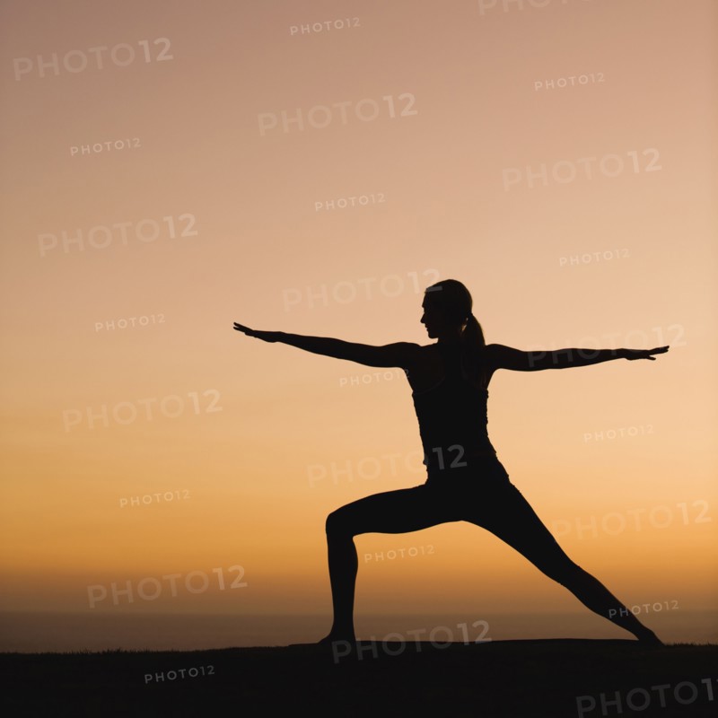 Silhouette of woman doing yoga