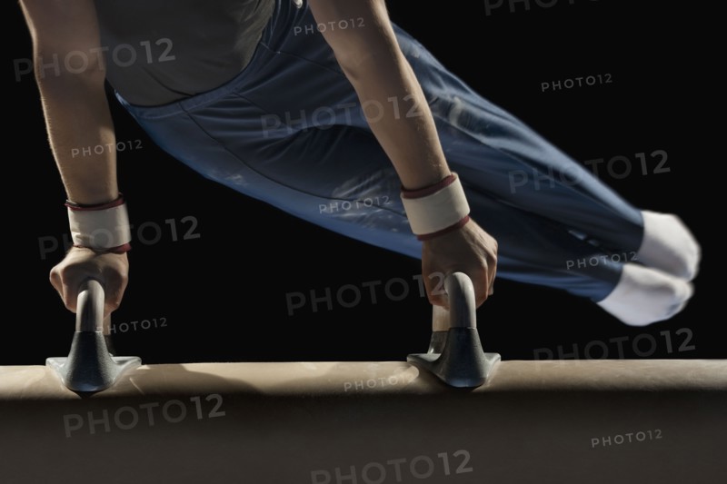 Gymnast swinging on pommel horse