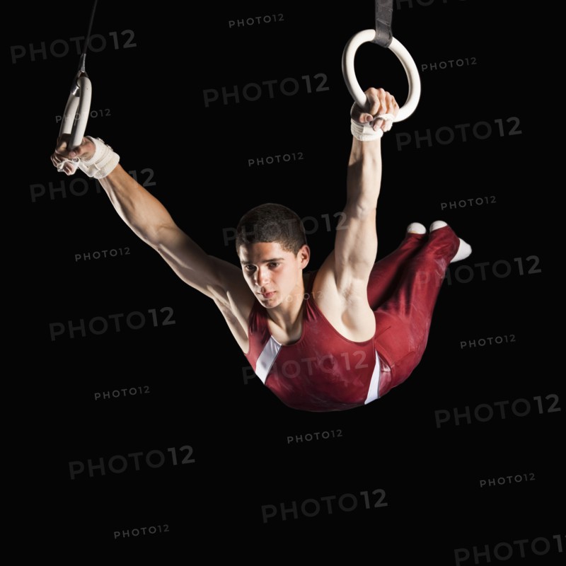 Gymnast swinging from rings