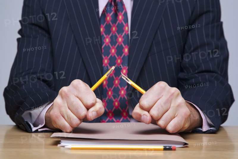 Man breaking pencil