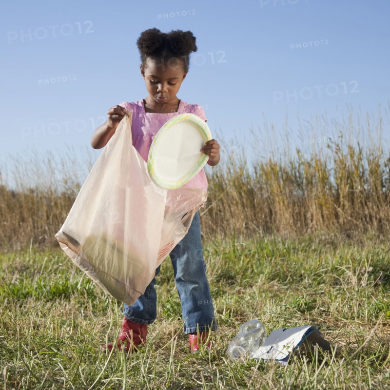 Young girl picking up litter