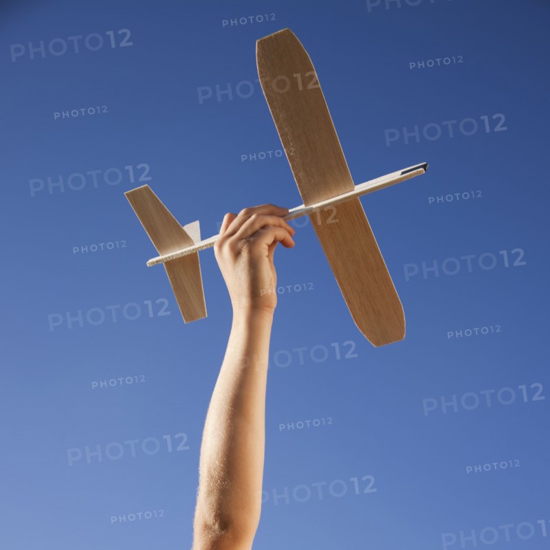 Hand holding toy plane