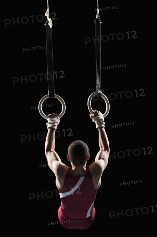 Gymnast swinging from rings