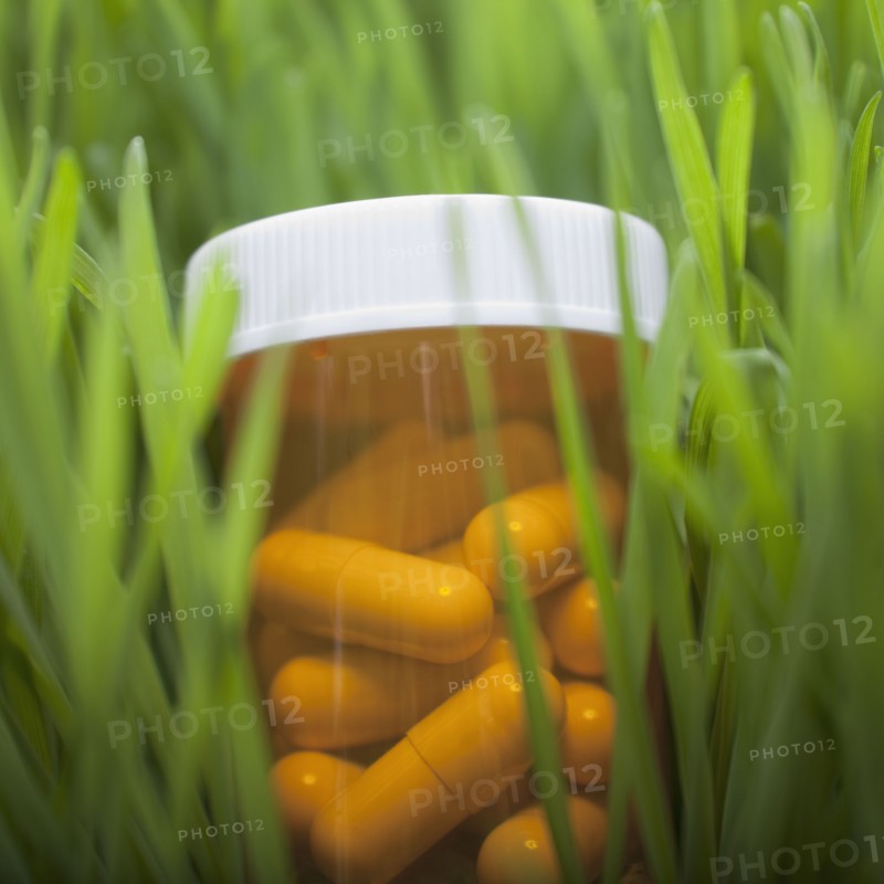 Bottle of pills in grass