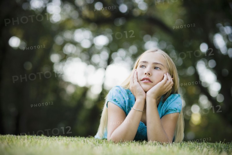 Young girl lying on grass