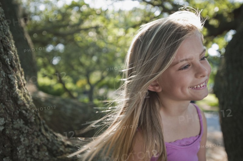 Girl beside tree