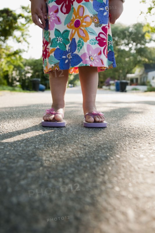 Young girl wearing flip flops