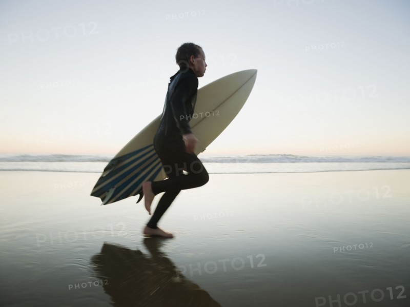 Child running with surfboard