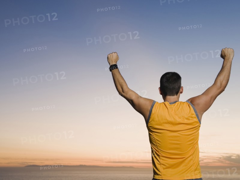 Man raising arms