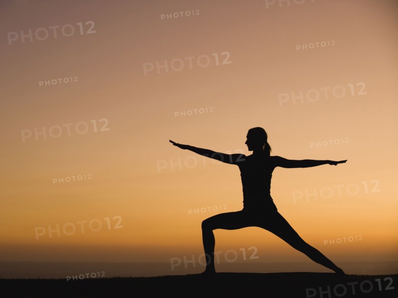 Silhouette of woman doing yoga