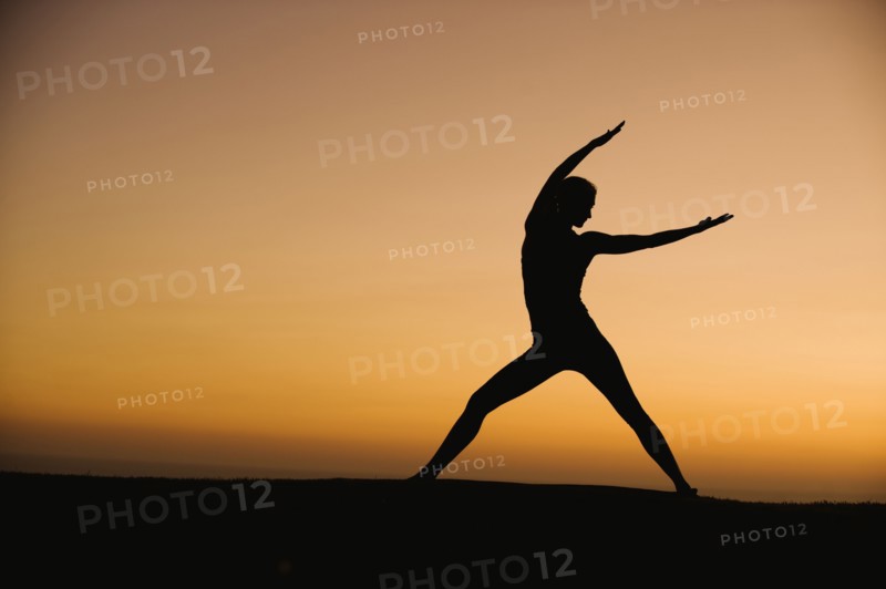 Silhouette of woman doing yoga