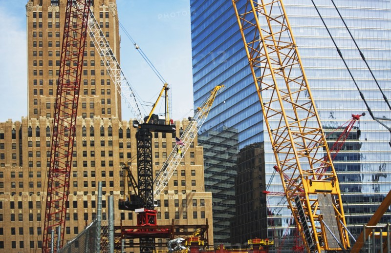 Cranes in front of buildings