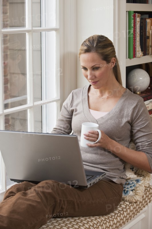 Woman working on laptop.