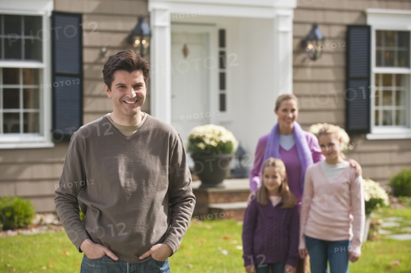 Family in front of house.