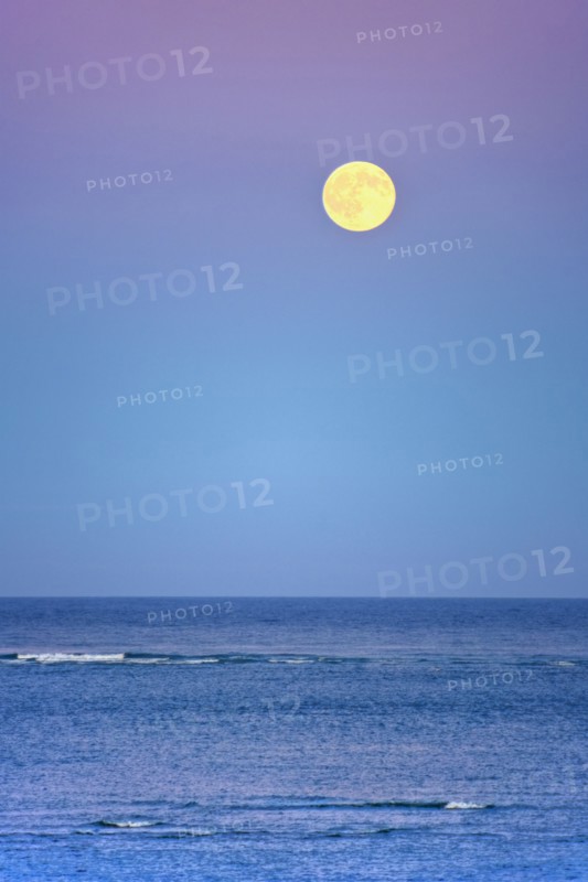 Moonrise over ocean.