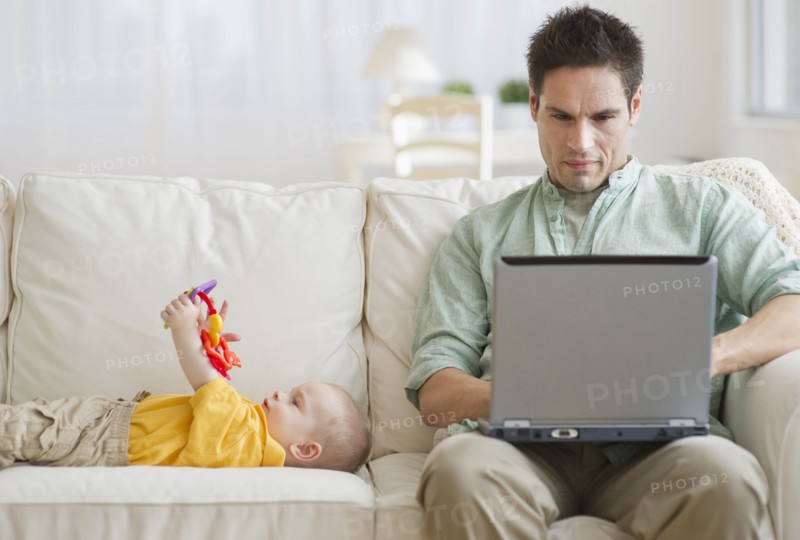 Father and son on couch.