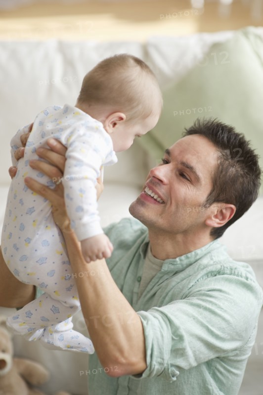 Father holding baby.