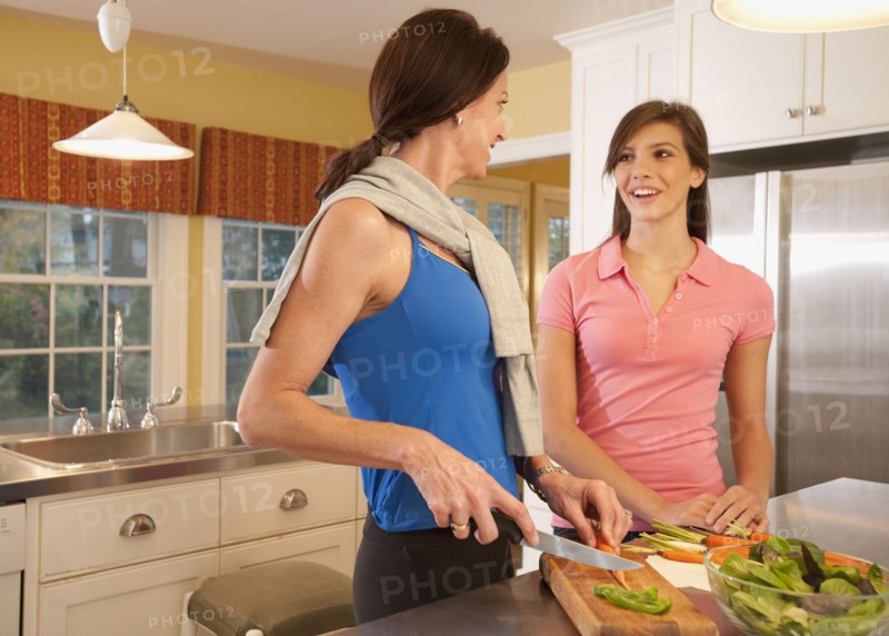 Mother and daughter in kitchen. Photographer: mark edward atkinson