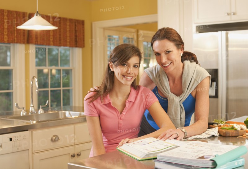Mother and daughter in kitchen. Photographer: mark edward atkinson