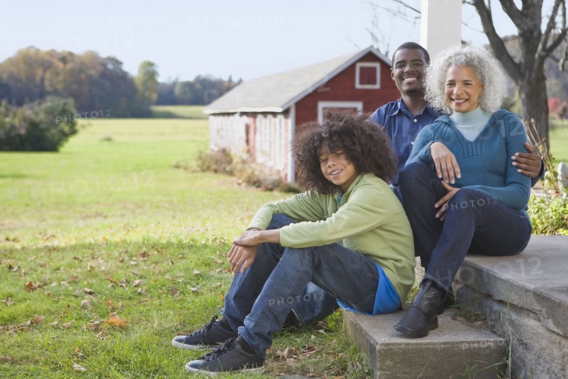 Family sitting on porch. Photographer: Pauline St.Denis