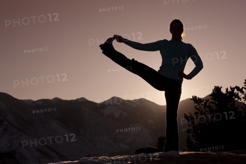Woman doing yoga outdoors. Photographer: Dan Bannister