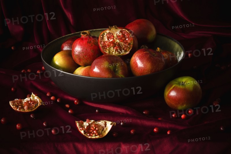 Bowl of pomegranates and apples. Photographer: Joe Clark