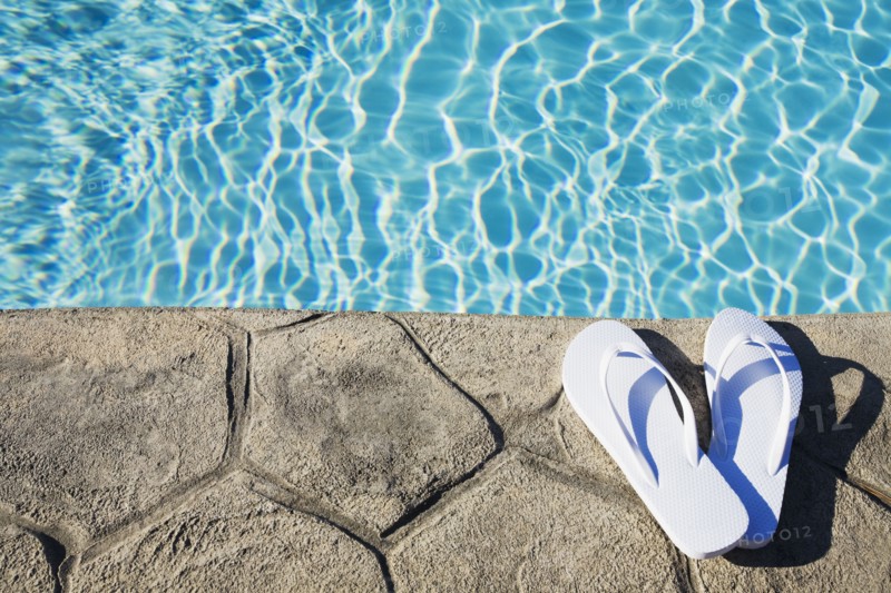 Flip flops by the pool. Photographer: Chris Hackett