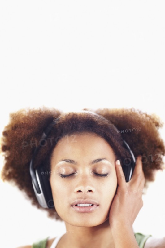 Woman listening to music. Photographer: momentimages