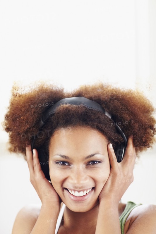 Woman listening to music. Photographer: momentimages
