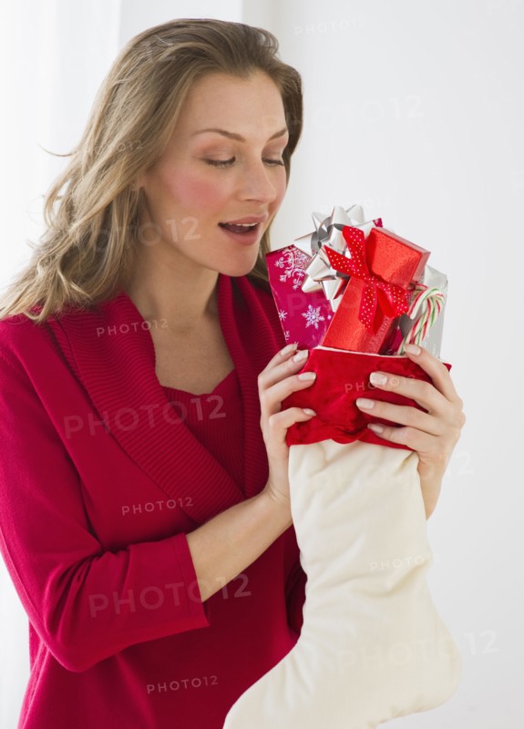 Woman holding Christmas stocking.