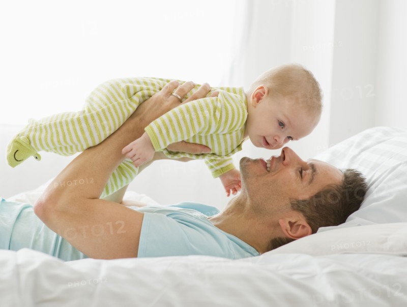 Father and baby playing.