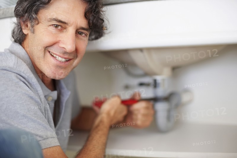 Fixing a leaky sink. Photographer: momentimages