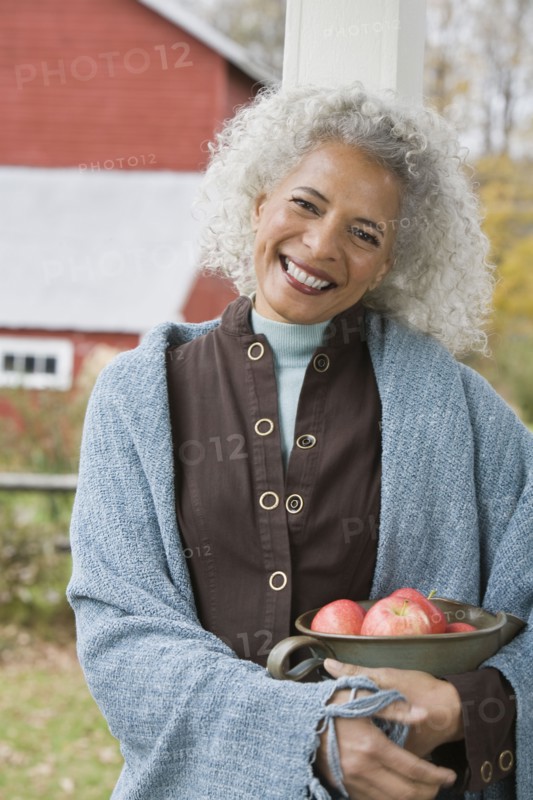 Woman holding bowl of apples. Photographer: Pauline St.Denis